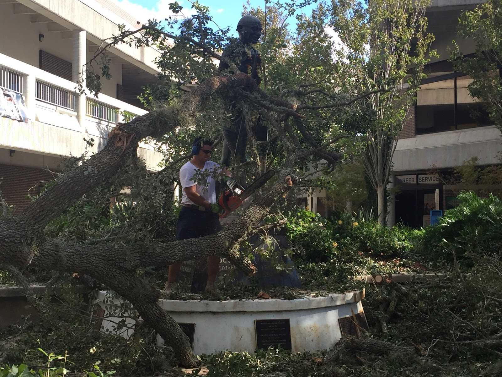 UNF alumni Juan Carlos Villatoro came to campus to help clear debris from the Ghandi statue after Hurricane Matthew. Photo by Pierce Turner