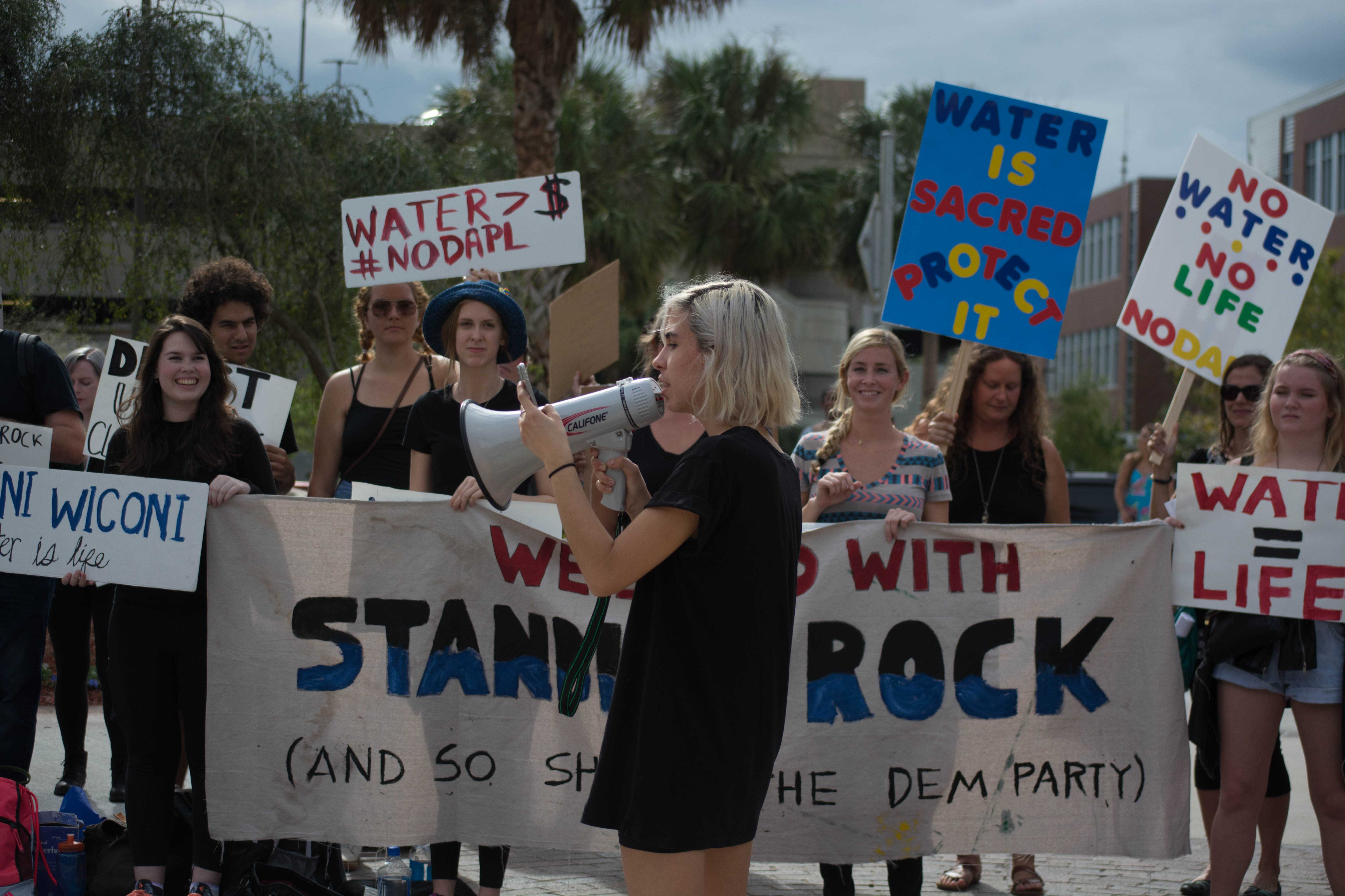 Students protest outside of the Hillary Clinton rally on campus. Photo by Lili Weinstein