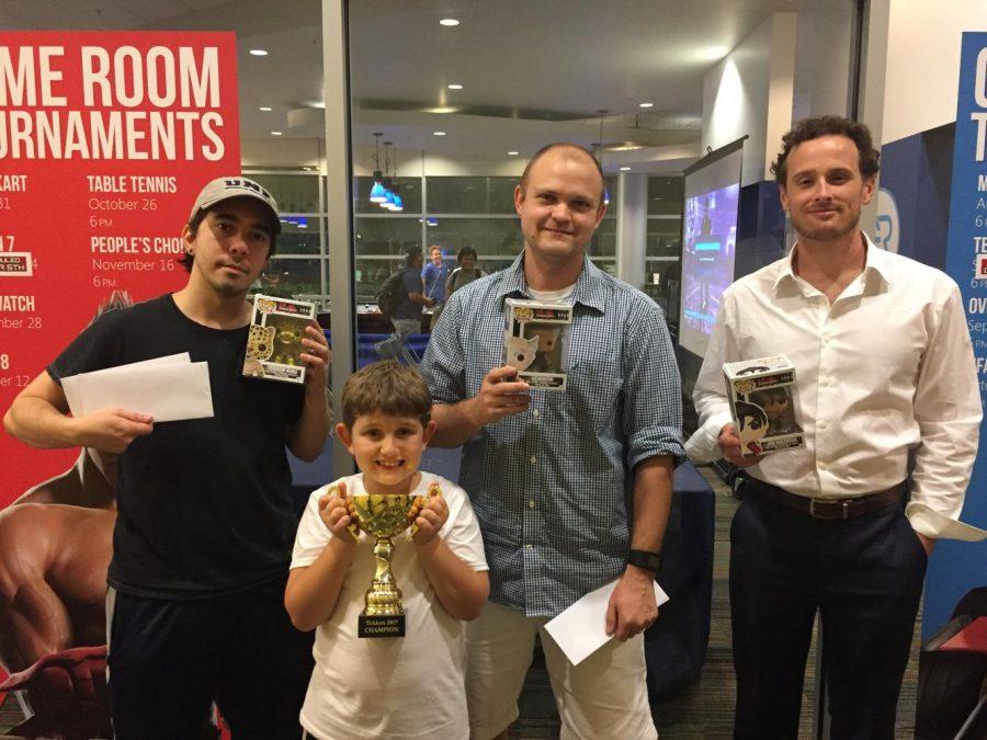 The winners and their prizes (From left to Right) Tereance Keller and his son, Charlie Nuzum and Matthew Smith. Photo by Tristan Reyes.
