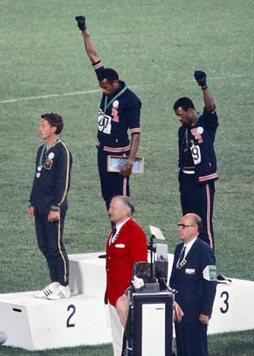 Tommie Smith (center) and John Carlos (right)