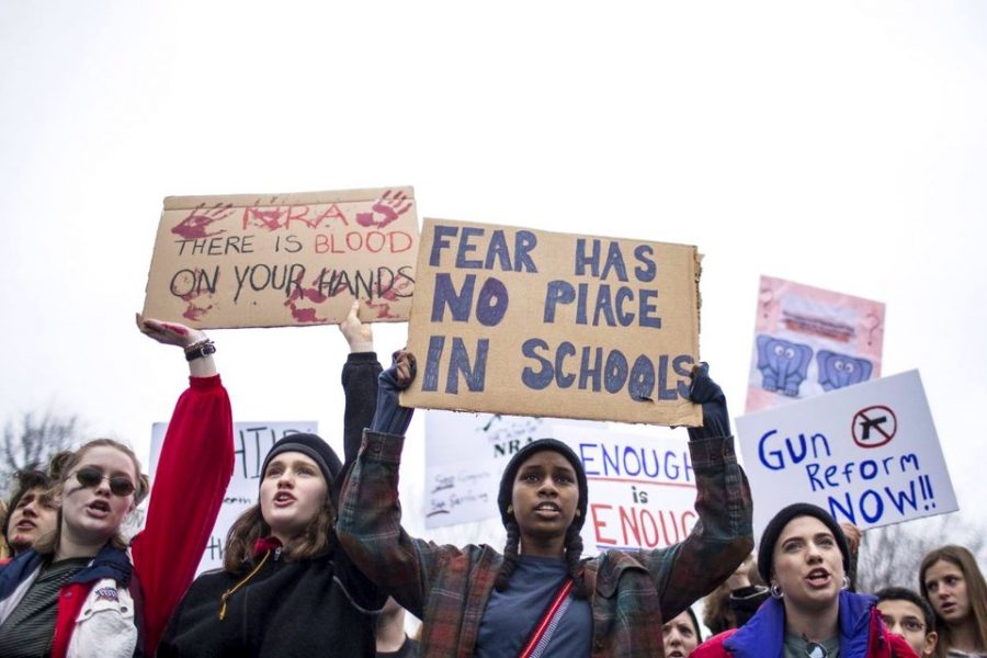 Students hold signs at a lie-in demonstration supporting gun control reform in Washington, D.C. February 18, 2018. Photo by Zach Gibson/Getty Images