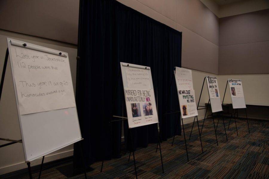 Another array of posters lining the wall of the town hall meeting room.