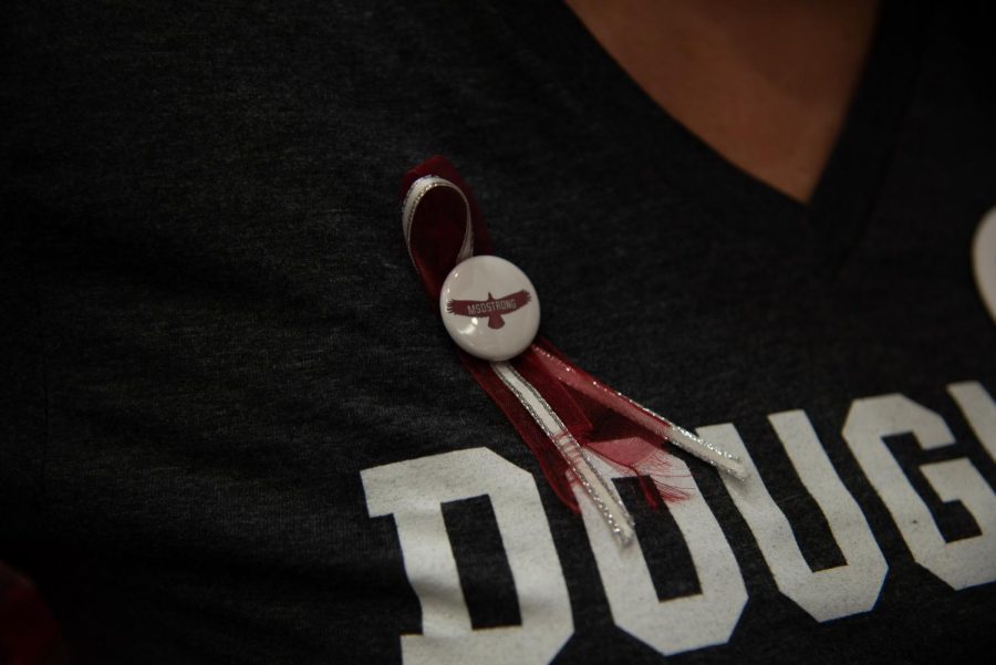 A MSD ribbon and pin on one of the event organizers.