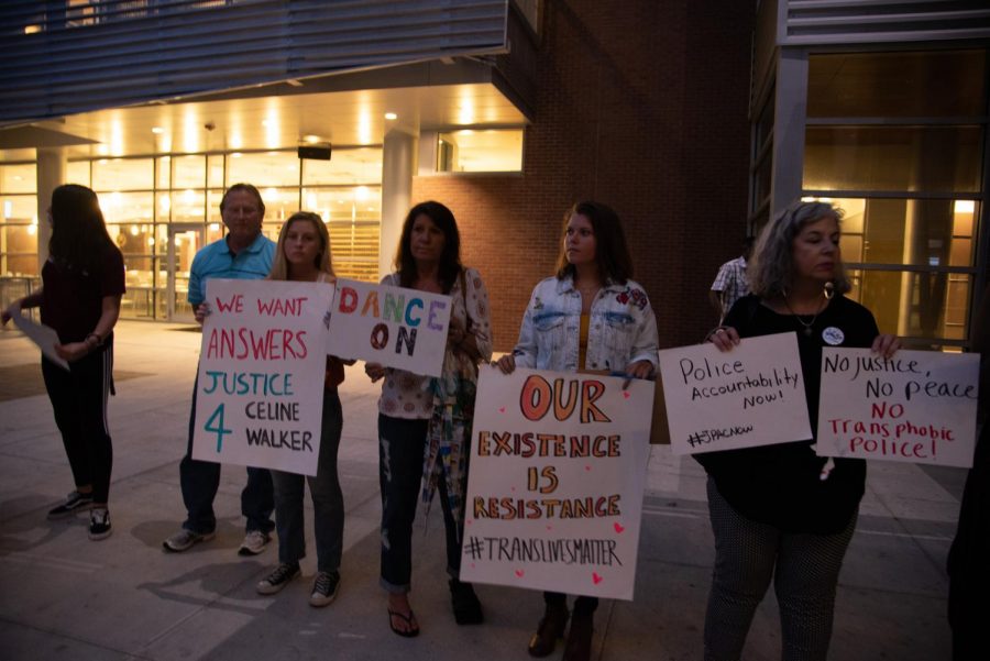 Town hall goers holding signs at the vigil.