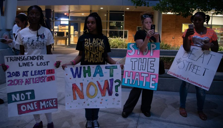 Student activists holding signs during the vigil.