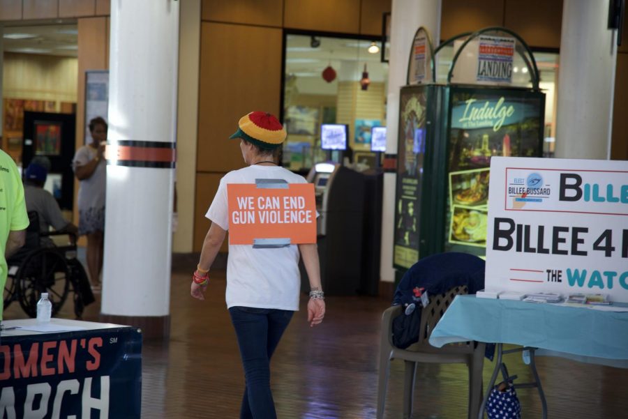 Attendee wears sign stating "We can end gun violence".