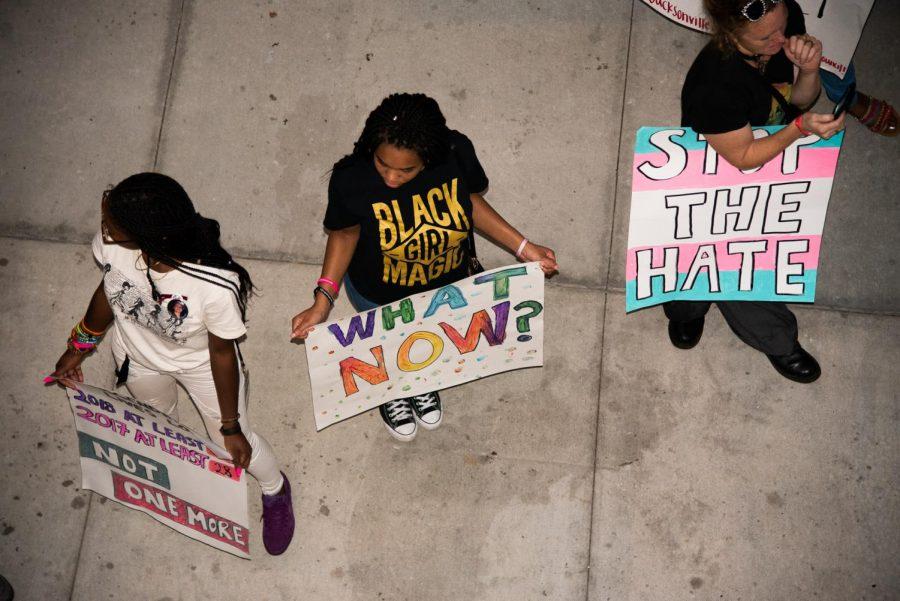 Danielle Williams and Aaliyah Eastman holding signs at the vigil.