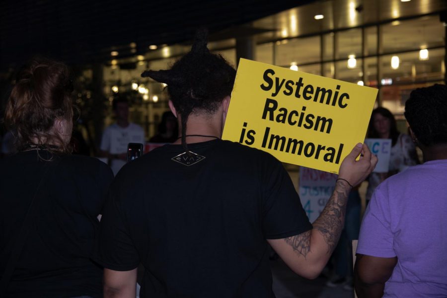 Dequan Franks holding a sign at the vigil.