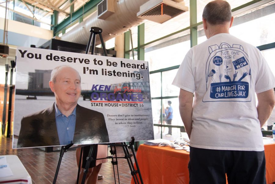 Ken Organes stands beside a board for Ken Organes.