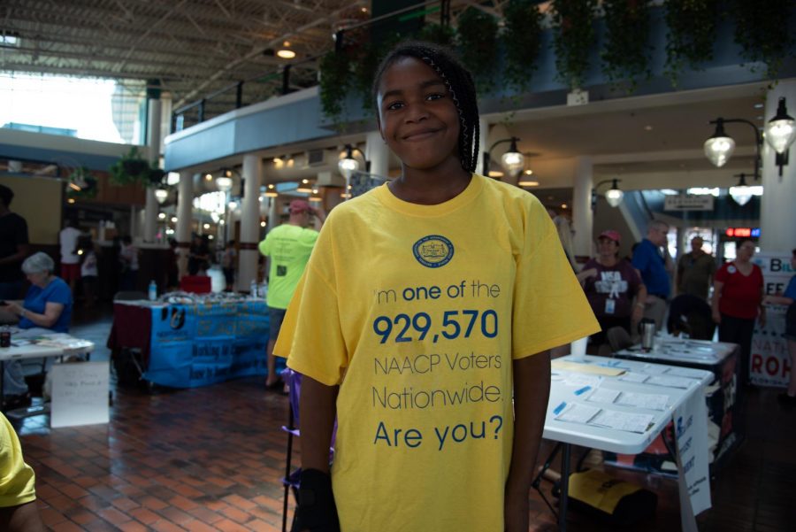 An attendee of the rally wears a shirt stating, "I'm one of the 929,570 NAACP voters nationwide. Are you?"