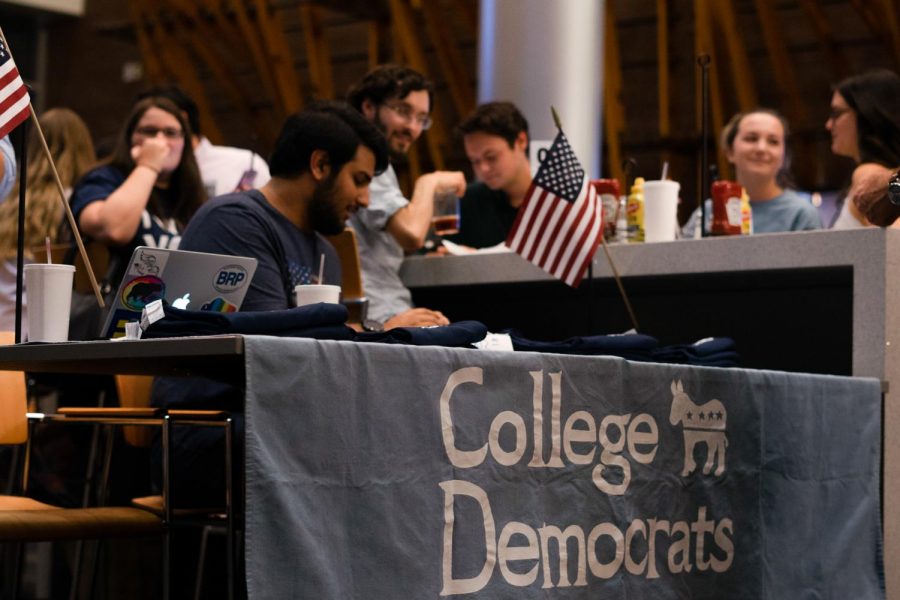 College Democrats table with t-shirts and sign-up sheet.