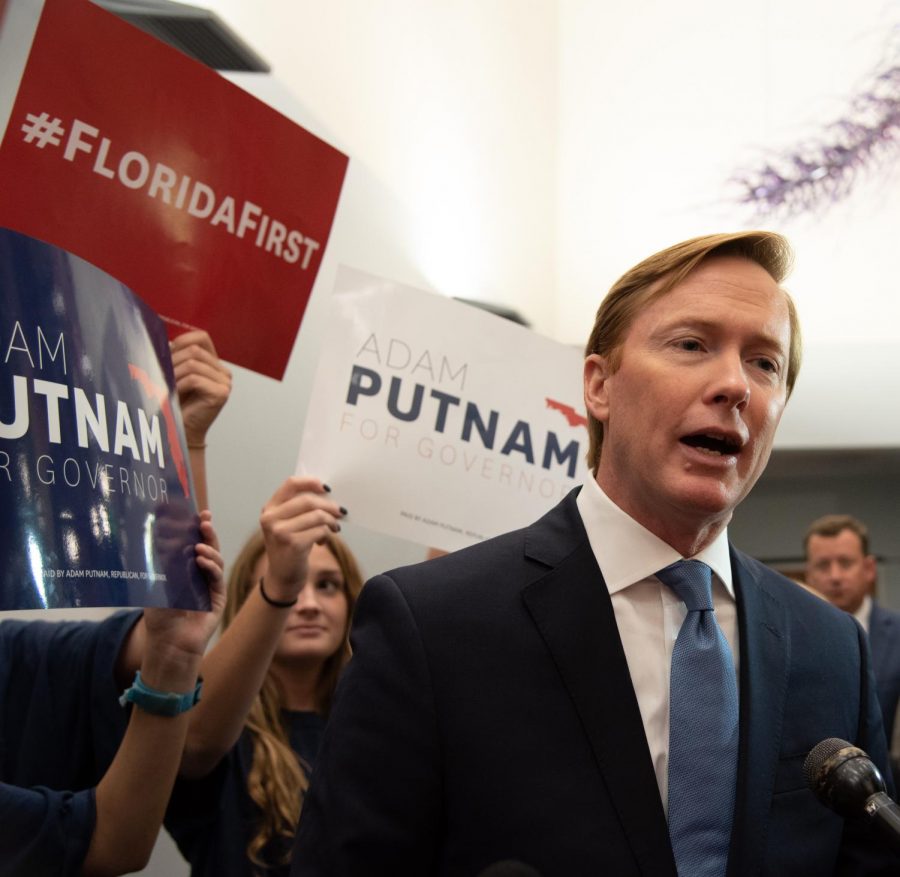 Adam Putnam answers questions for the press.