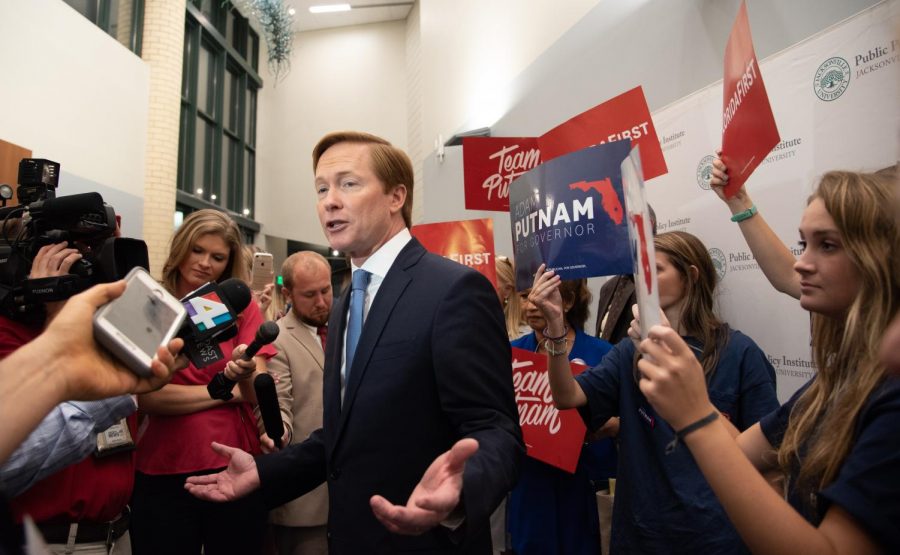 Adam Putnam addresses the press with his supporters rallying behind him.