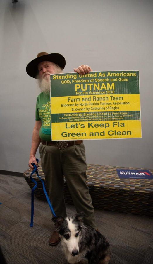 An Adam Putnam supporter (and his dog) listening in on Putnam's questions from the press.