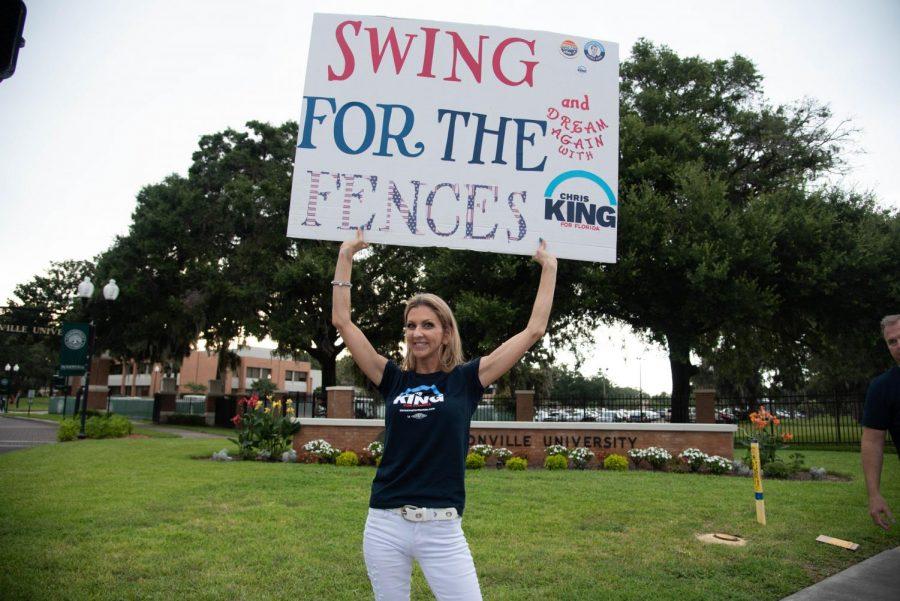A woman with a hand made sign in support of Chris King