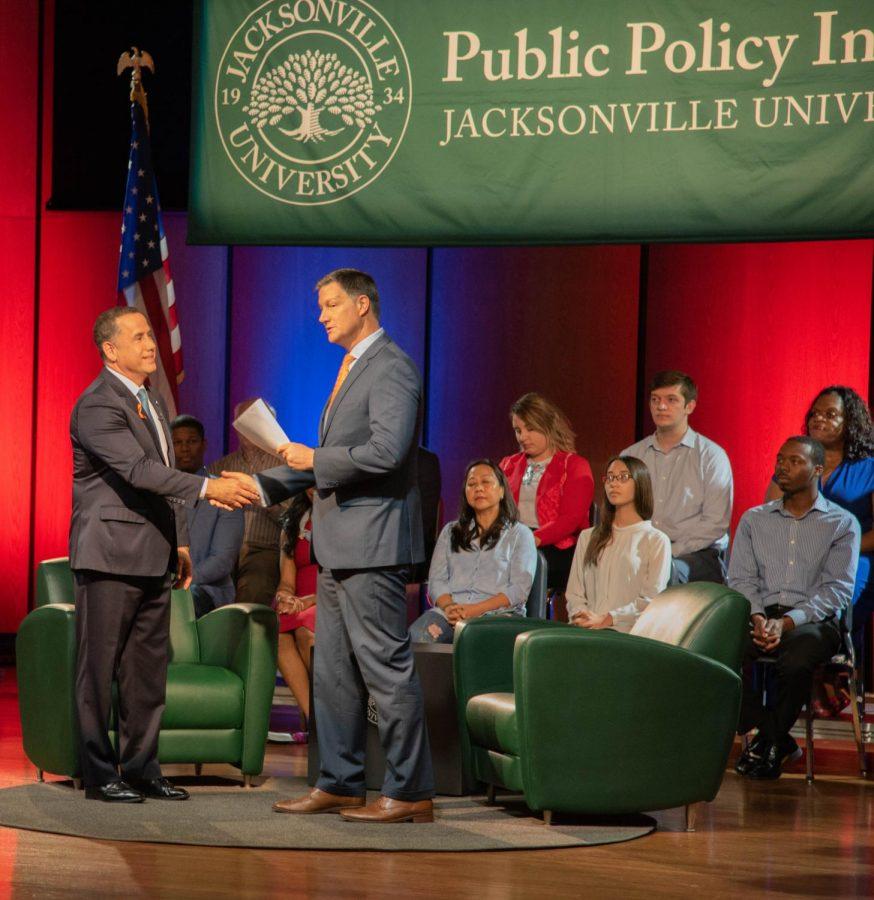 Philip Levine is greeted by Kent Justice to start the Town Hall Forum on August 9.