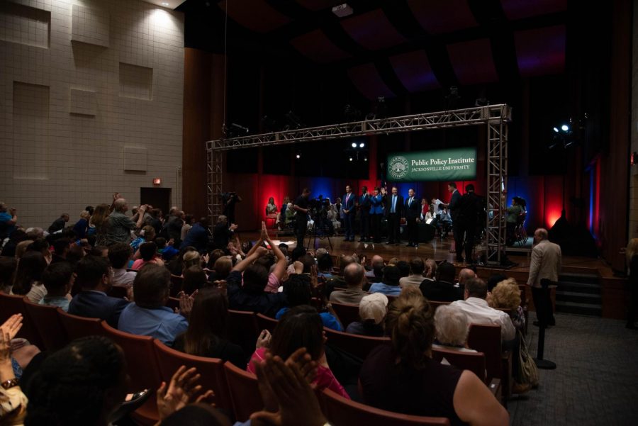 The studio audience stands in applause of the five gubernational hopefuls.