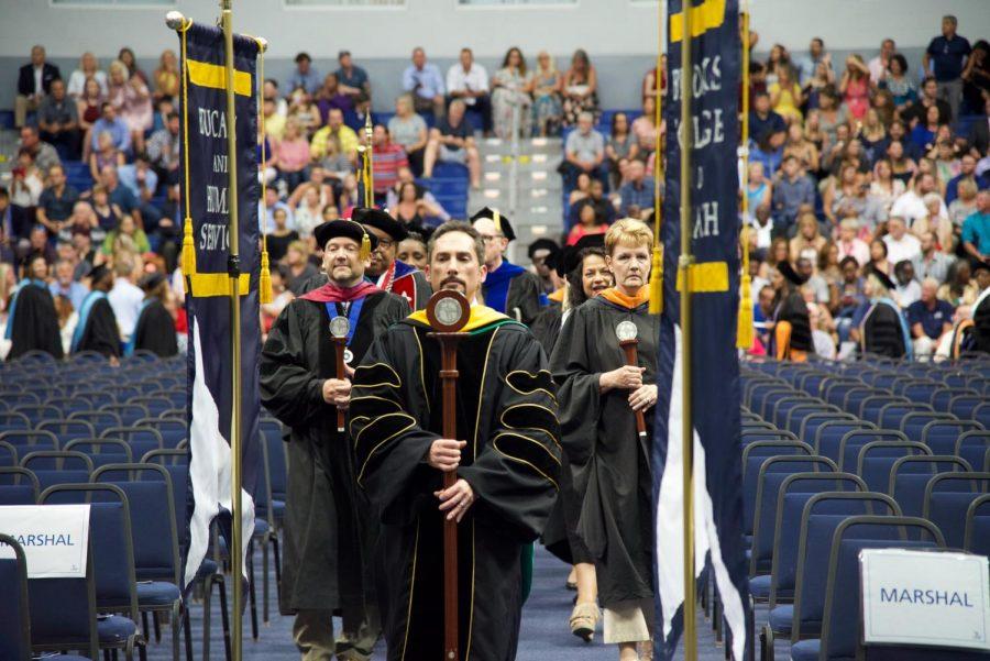 Graduates being led down the aisle to their seats.
