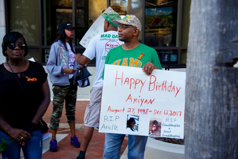 Peaceful protester holds sign to celebrate the birthday of a loved one who past away due to violence. 
