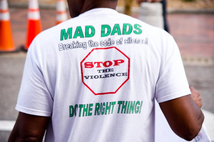 Attendee wears shirt supporting stopping violence.