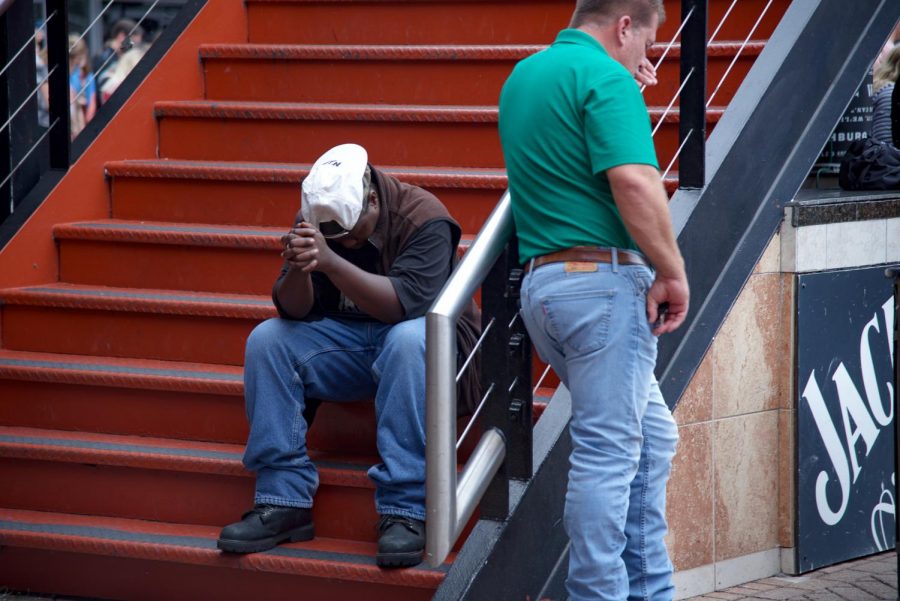Attendee praying for the lives lost in The Landing shooting.