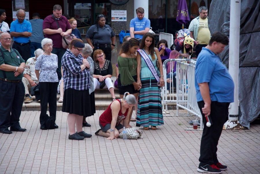 Attendees praying for the lives lost in The Landing shooting.