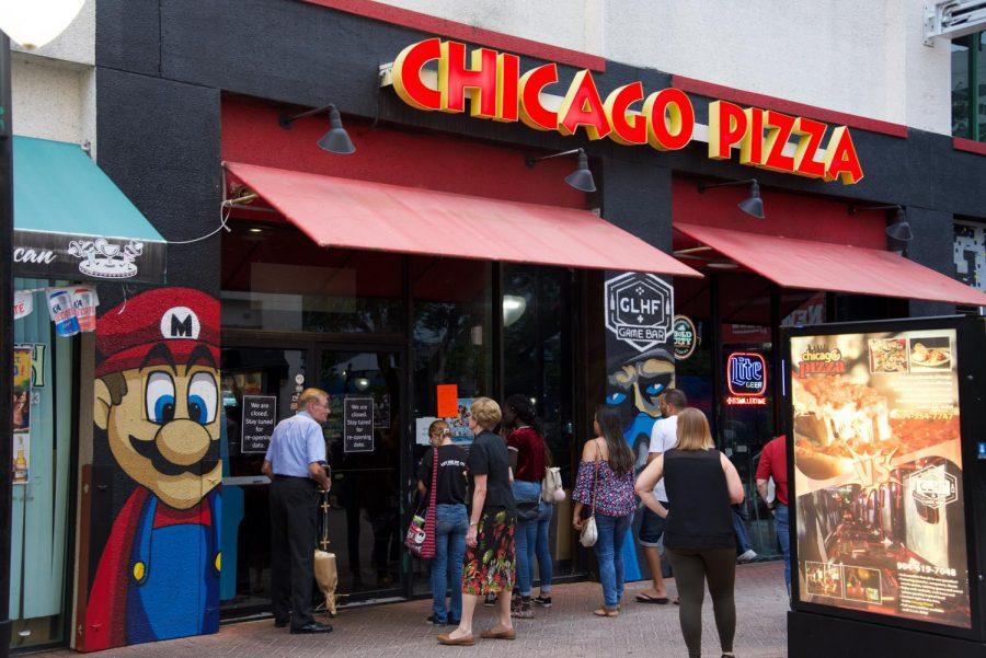 Attendees visiting Chicago Pizza after the vigil.