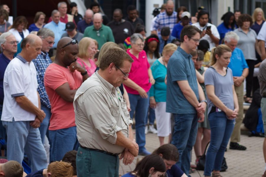 Attendees showing respect for the lives lost in The Landing shooting.