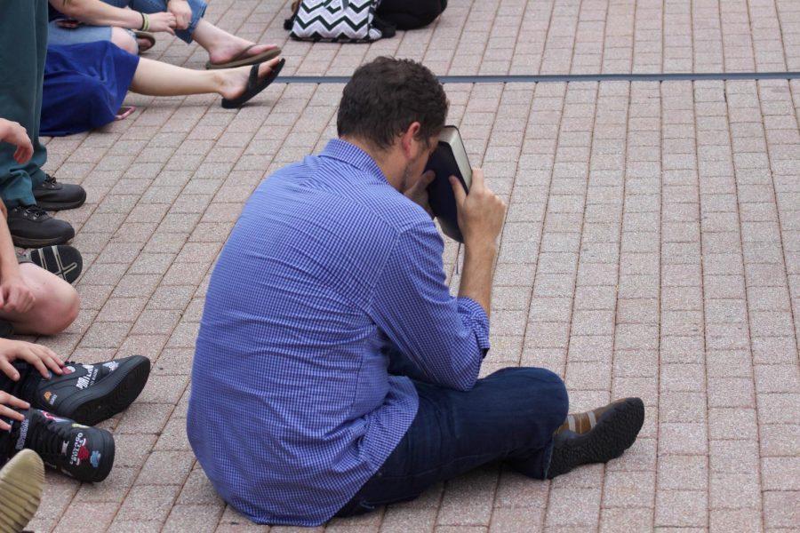 Attendee showing respect for the lives lost in The Landing shooting.