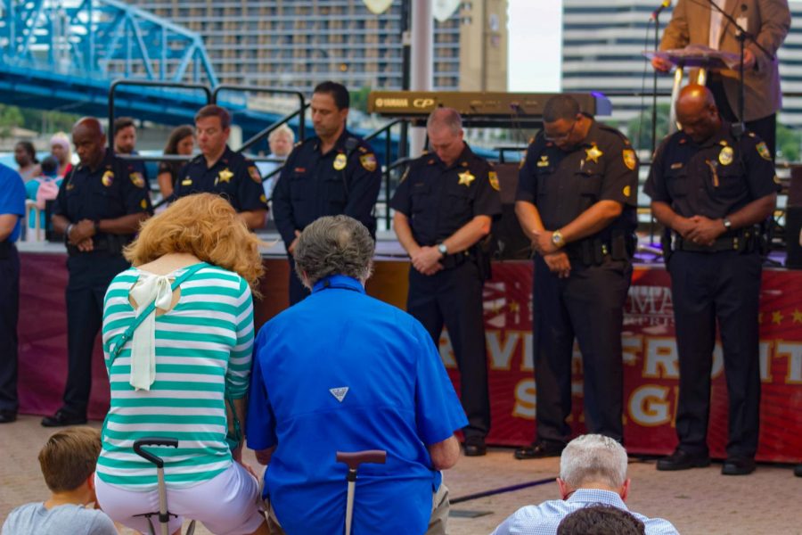 JSO and attendees showing respect in remembrance of the lives lost at The Landing shooting.