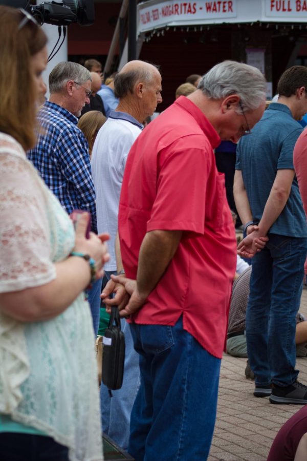 Attendees praying in remembrance of the lives lost at The Landing shooting.