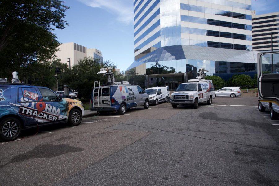 Local news trucks line the streets by The Landing.