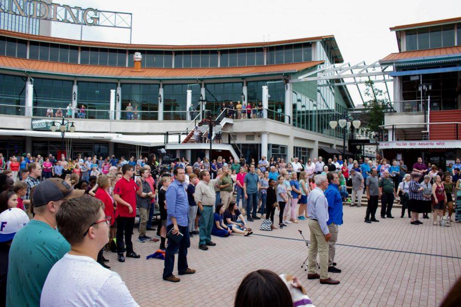 Attendee showing respect for the lives lost in The Landing shooting.