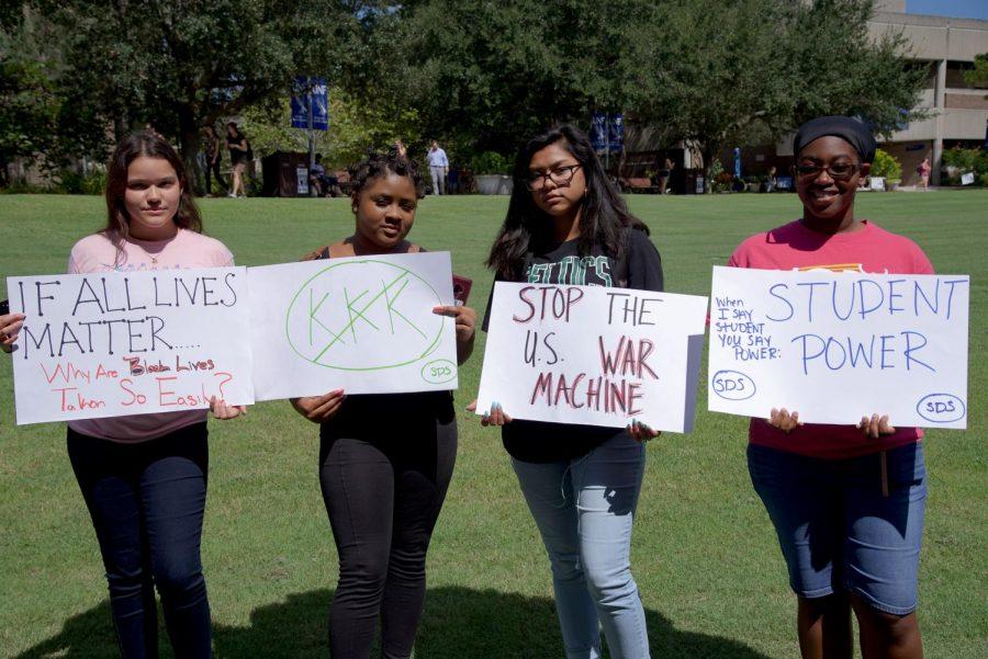 Attendees holding signs.