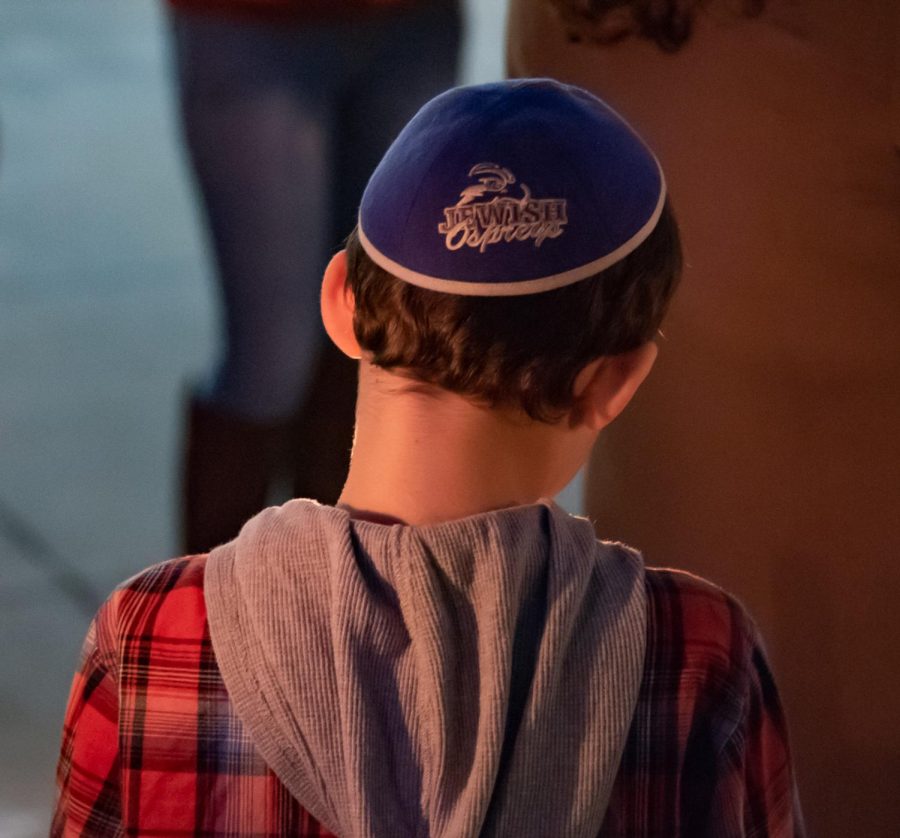 Child wearing Jewish Ospreys yarmulke.