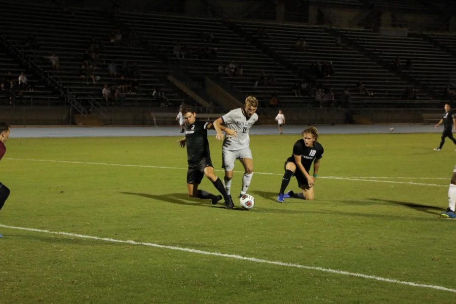 Bryson Smith challenges a defender inside the box. 