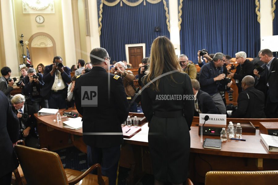 Jennifer Williams, right, an aide to Vice President Mike Pence, and National Security Council aide Lt. Col. Alexander Vindman, stand to take a break as they testify before the House Intelligence Committee on Capitol Hill in Washington, Tuesday, Nov. 19, 2019, during a public impeachment hearing of President Donald Trump's efforts to tie U.S. aid for Ukraine to investigations of his political opponents. (AP Photo/Susan Walsh)