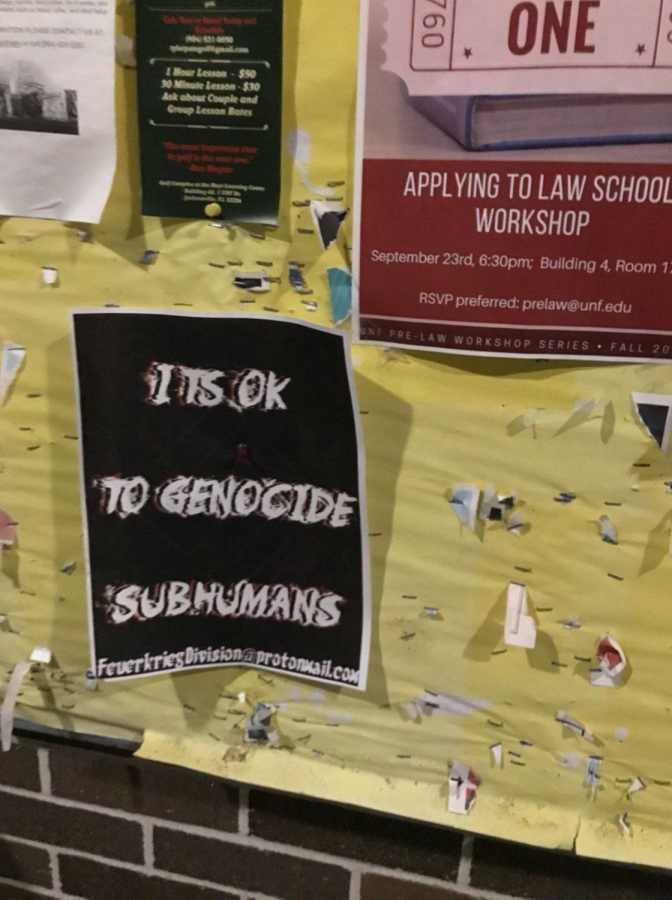 A neo-Nazi flyer next to what appears to be a UNF pre-law program poster.