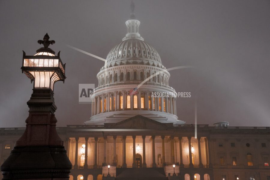 The U.S. Capitol in Washington is shrouded in mist, Friday night, Dec. 13, 2019.  This coming week’s virtually certain House impeachment of President Donald Trump will underscore how Democrats and Republicans have morphed into fiercely divided camps since lawmakers impeached President Bill Clinton.(AP Photo/J. Scott Applewhite)