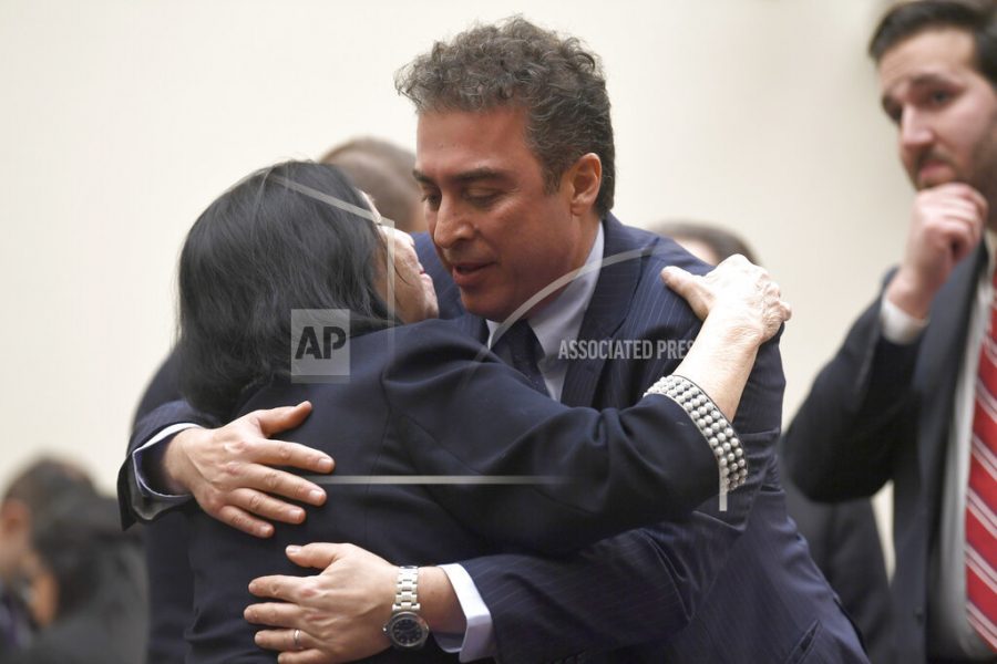 FILE - In this March 7, 2019, file photo, Christine Levinson, wife of Robert Levinson, a former FBI agent who vanished in Iran in 2007, left, gets a hug from Babak Namazi, right, the son of Baquer Namazi who has been held in Iran, following their testimony before a House Foreign Affairs Subcommittee on Capitol Hill in Washington. The killing of a top Iranian general has ratcheted up the anxiety of families of Americans held in Iran.  (AP Photo/Susan Walsh, File)