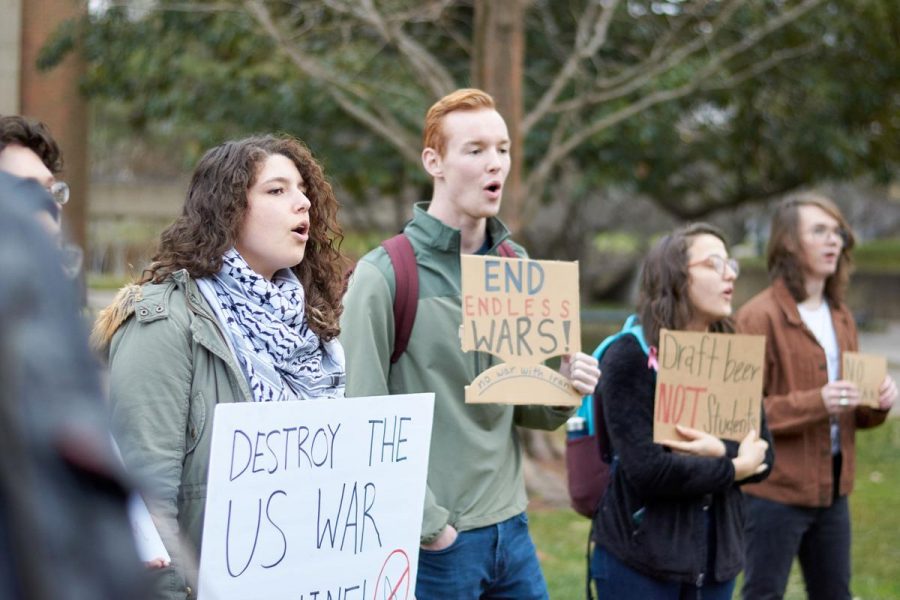 A group of protesters join in a chant protesting a possible Iran war, in the HSS amphitheater on Thursday, January 9th, 2020.