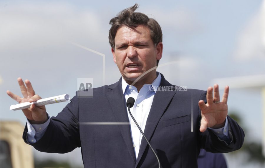 Florida Gov. Ron DeSantis speaks during a news conference at a drive-through coronavirus testing site in front of Hard Rock Stadium, Monday, March 30, 2020, in Miami Gardens, Fla. Gov. Ron DeSantis doesnt want the people on the Holland Americas Zandaam where four people died and others are sick to be treated in Florida, saying the state doesnt have the capacity to treat outsiders as the coronavirus outbreak spreads. (AP Photo/Wilfredo Lee)