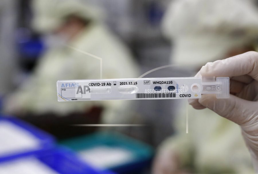 CAPTION ADDITION ADDS PRODUCTS USE: An employee holds up an antibody test cartridge of AFIAS COVID-19 Ab testing kit used in diagnosing the coronavirus for a photograph on a production line of the Boditech Med Inc. in Chuncheon, South Korea, Friday, April 17, 2020. Boditech Med recently started exporting its antibody-based virus test kits to various countries. The product shown is fluorescence Immunoassay that can be used in general antibody tests but not in rapid tests.(AP Photo/Lee Jin-man)