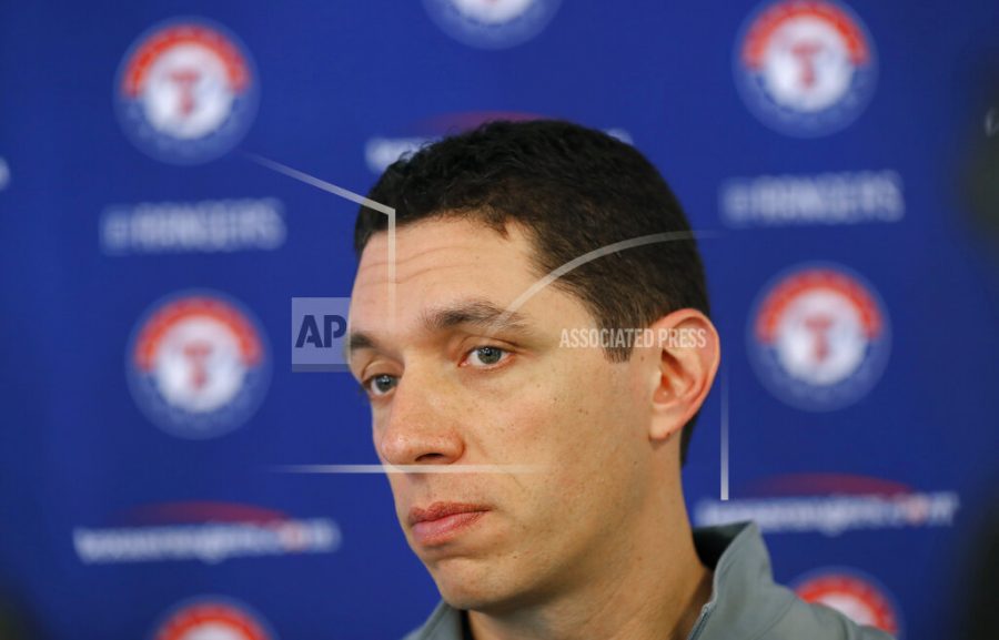 FILE - In this Feb. 15, 2018, file photo, Texas Rangers general manager Jon Daniels speaks to reporters during baseball spring training in Surprise, Ariz. Will there be a place to play whether a draft prospect decides to go, or stay in college? “I think there’s a host of information that you’d want to know, and then that’s really where I think the clubs can differentiate themselves,” Daniels said. (AP Photo/Charlie Neibergall, File)
