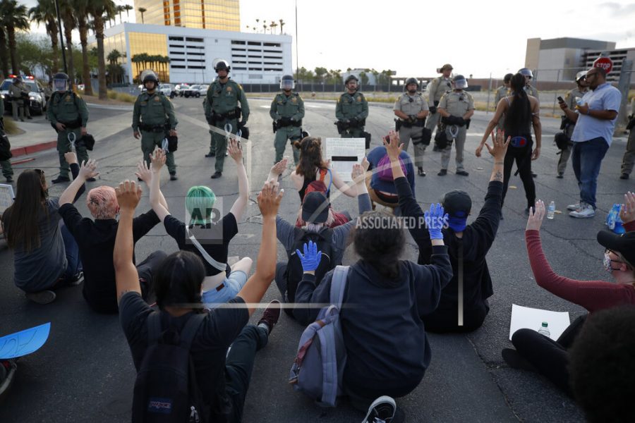 Protesters rally at Trump International Hotel Las Vegas, Monday, June 1, 2020, in Las Vegas, over the death of George Floyd. Floyd died after being restrained by Minneapolis police officers on May 25. (AP Photo/John Locher)