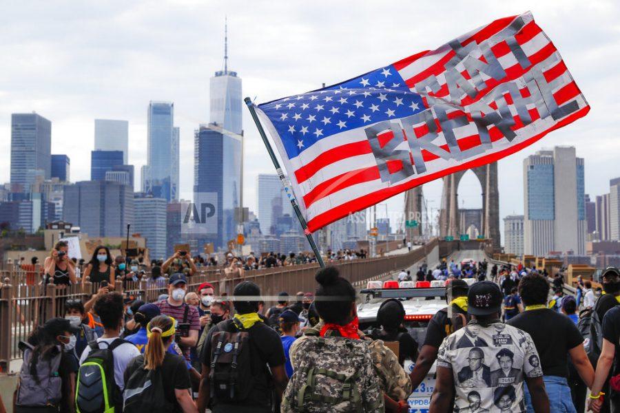 Protesters march on the Brooklyn Bridge after a rally in Cadman Plaza Park, Thursday, June 4, 2020, in New York. Protests continued following the death of George Floyd, who died after being restrained by Minneapolis police officers on May 25. (AP Photo/John Minchillo)