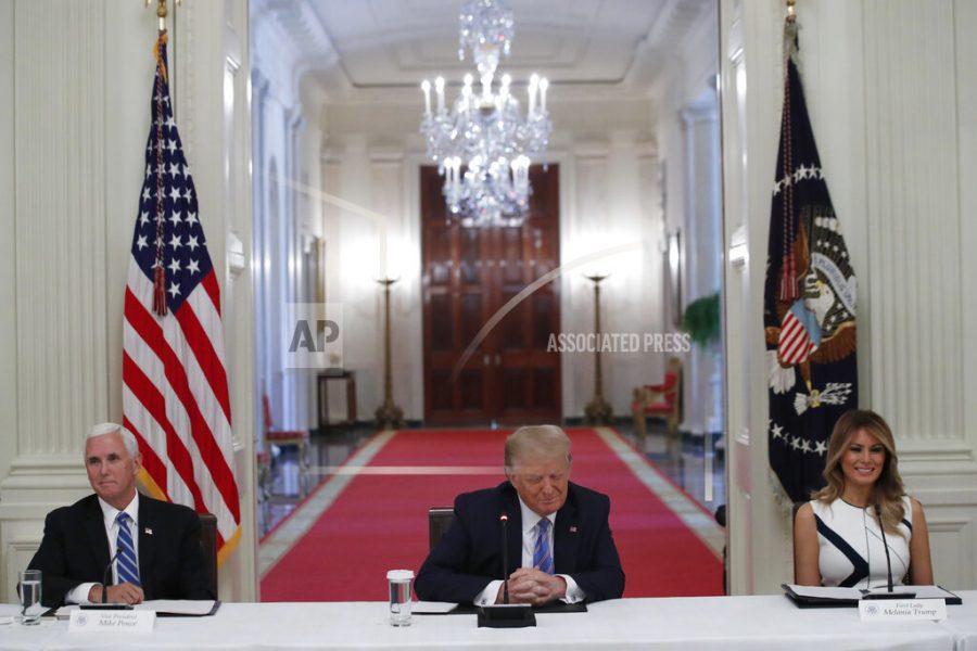 President Donald Trump, Vice President Mike Pence, left, and first lady Melania Trump, attend a National Dialogue on Safely Reopening Americas Schools, event in the East Room of the White House, Tuesday, July 7, 2020, in Washington. (AP Photo/Alex Brandon)