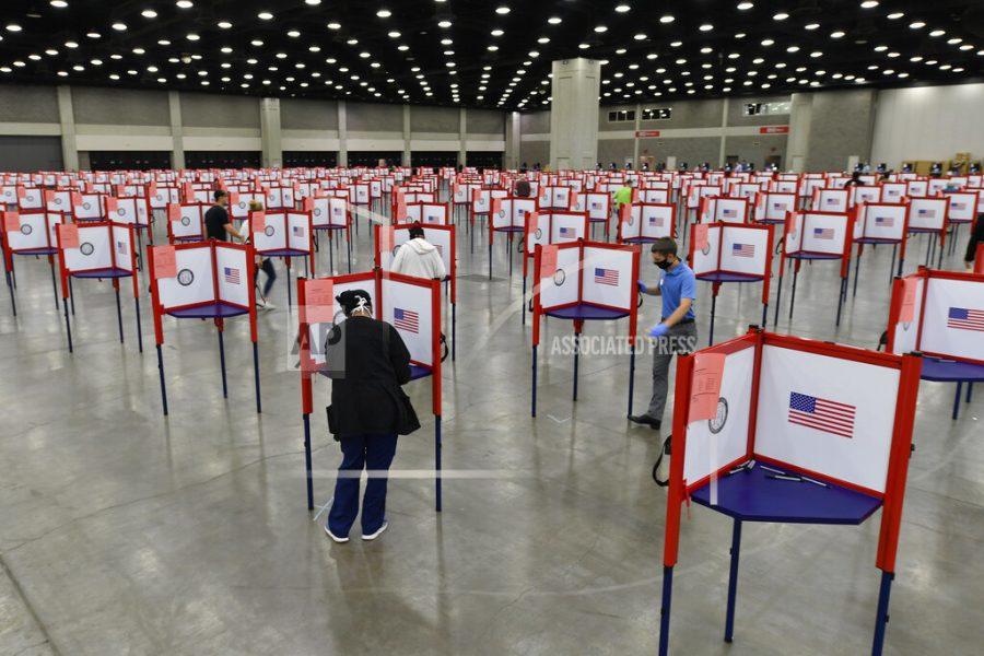 FILE - In this June 23, 2020, file photo voting stations are set up in the South Wing of the Kentucky Exposition Center for voters to cast their ballot in the Kentucky primary in Louisville, Ky. The November election is coming with a big price tag as America faces the coronavirus pandemic. The demand for mail-in ballots is surging, election workers are in need of training and polling booths might have to be outfitted with protective shields. (AP Photo/Timothy D. Easley, File)