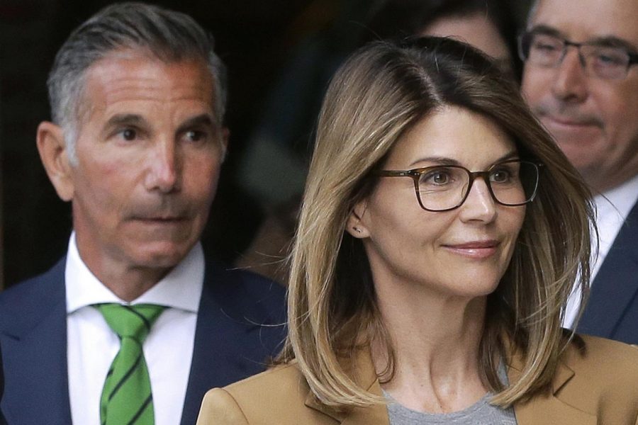 In this April 3, 2019 file photo, actress Lori Loughlin, front, and husband, clothing designer Mossimo Giannulli, left, depart federal court in Boston after facing charges in a nationwide college admissions bribery scandal. The famous couple pleaded guilty to charges in May 2020, and are scheduled to be sentenced on Friday, Aug. 21, 2020. (AP Photo/Steven Senne, File)
