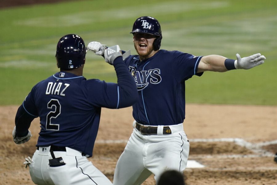 Tampa Bay Rays' Michael Brosseau, right, celebrates with Yandy Diaz after hitting a solo home run during the eighth inning in Game 5 of a baseball American League Division Series against the New York Yankees, Friday, Oct. 9, 2020, in San Diego. (AP Photo/Jae C. Hong)